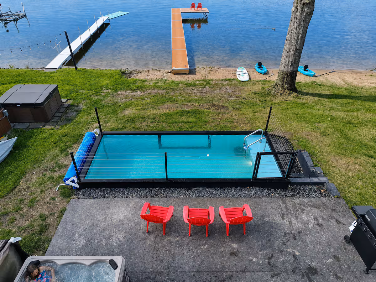Container pool installed on a lakefront lot beside a private dock